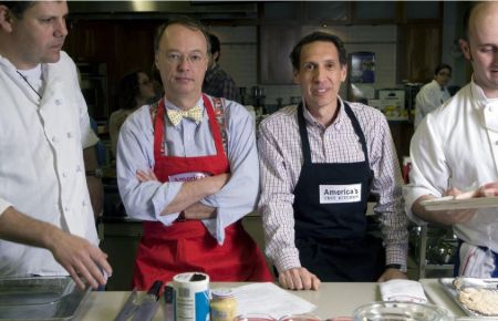 Christopher Kimball and Jack Bishop standing side by side at the set of America's Test Kitchen.