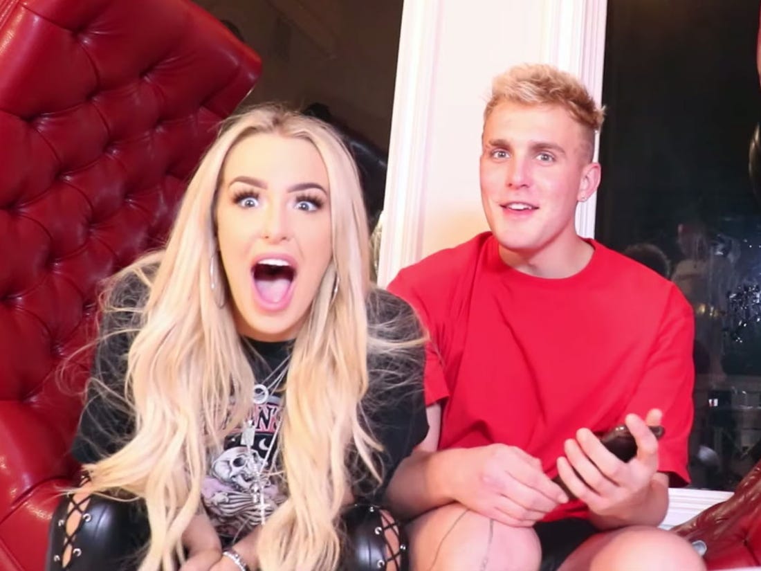tana and jake sitting on the couch talking 