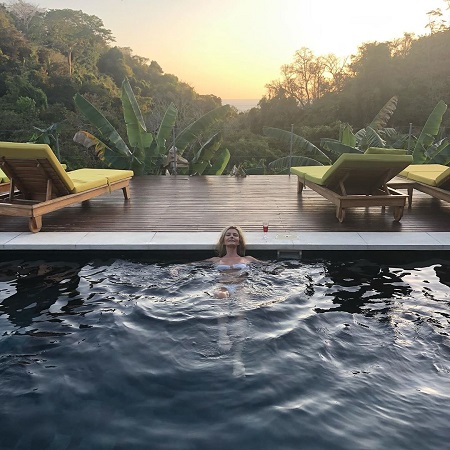 Paulina Porizkova in the pool of Villa Neruda, Hermosa Hills, overlooking the natural beauty behind her.