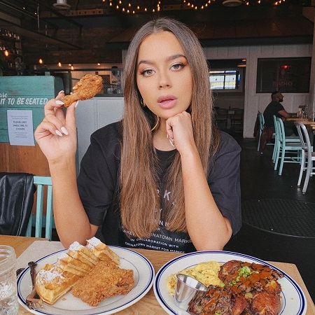 Tessa Brooks with two plates of food.