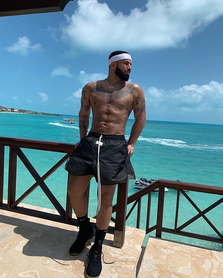 Drake's shirtless photo of himself in a hotel balcony overlooking the ocean.