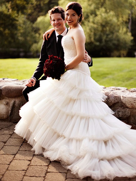 America Ferrera and husband Ryan Piers Williams on their wedding day in their wedding dresses.