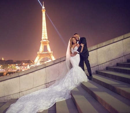 Adrienne Bailon and husband Israel Houghton on their wedding day with the Eiffel Tower at the back.