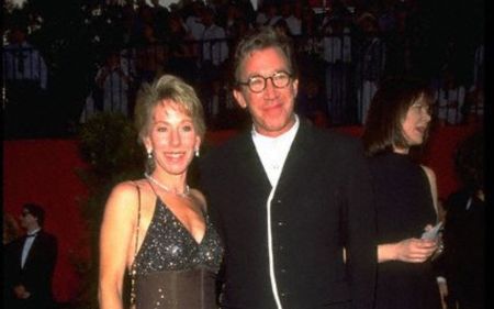 Laura Deibel och Tim Allen poserar för en bild vid en prisceremoni. 