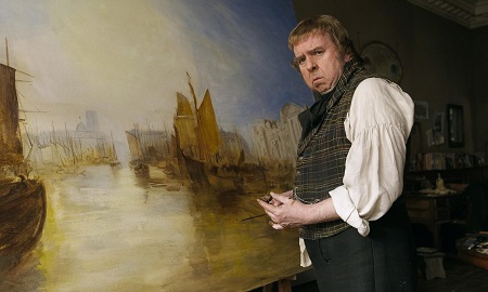 Timothy Spall in front of a painting.