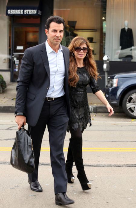Paula and Jon Caprio  walking out of shop holding  hand 