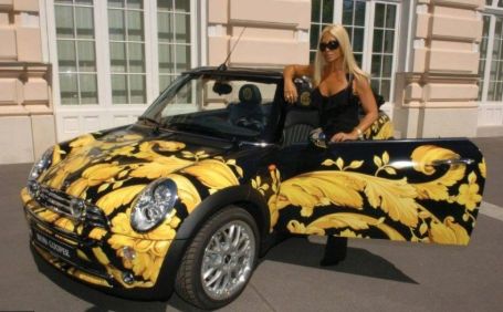 Donatella Versace with a black and yellow Mini Cooper.