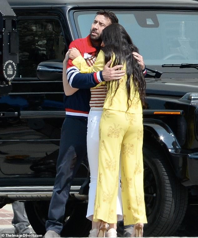 Nicolas Cage is hugging Demi Moore.