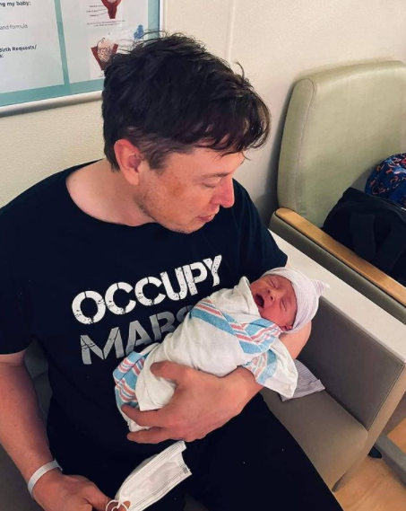 Elon Musk is with his son, baby X.